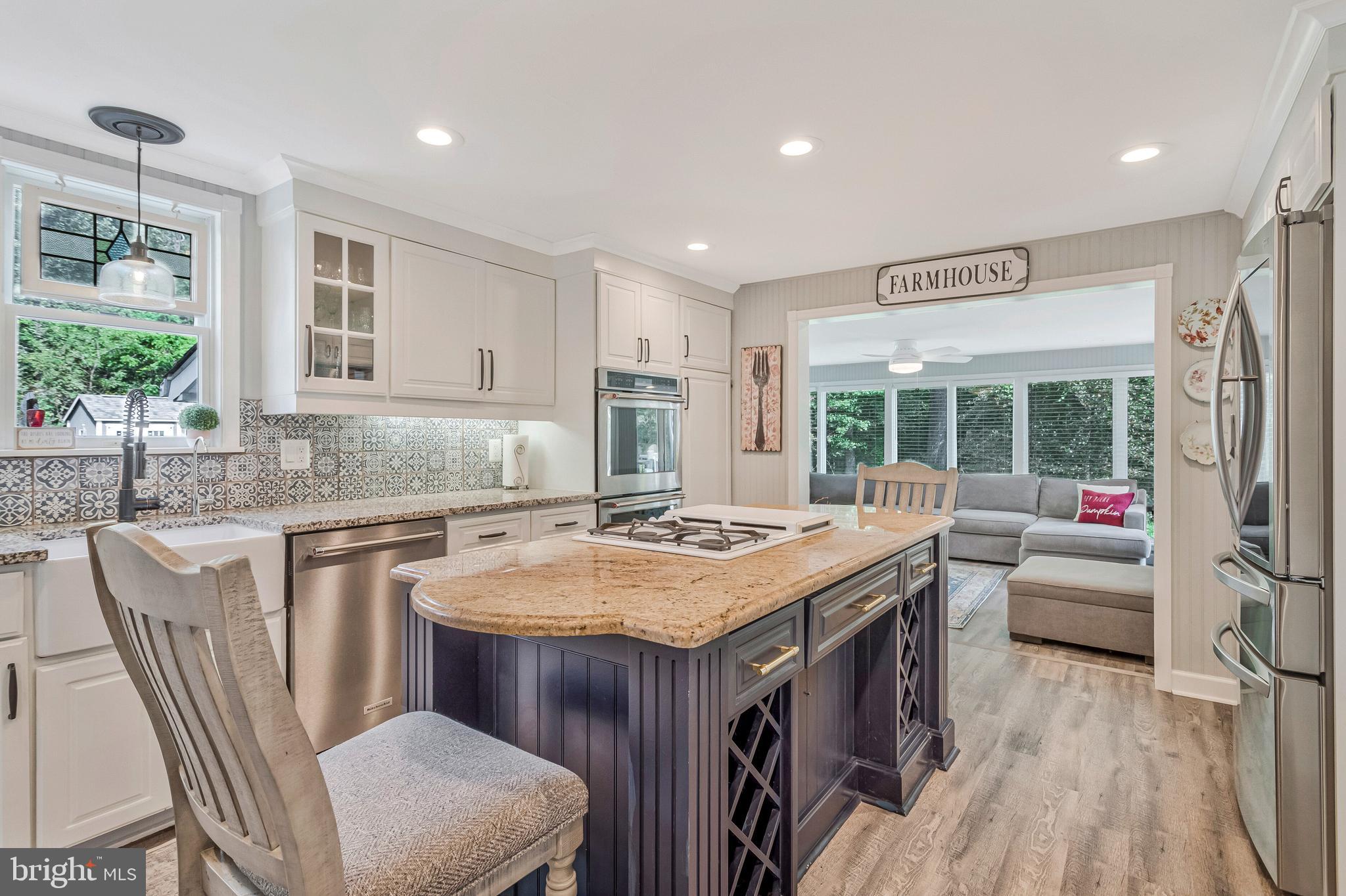 605 Barstow Road Prince Frederick, MD 20678 - Photo 16 of 57 a kitchen with a stove a sink a refrigerator dining table and chairs