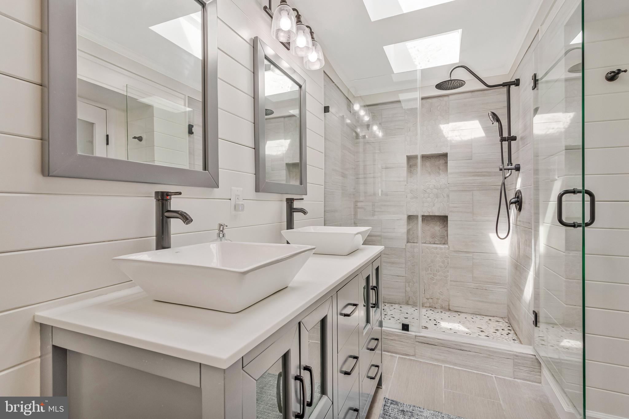 605 Barstow Road Prince Frederick, MD 20678 - Photo 30 of 57 a bathroom with a sink mirror and a shower