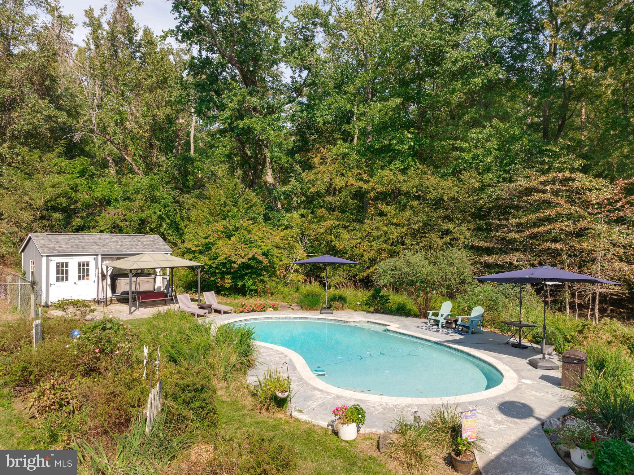 605 Barstow Road Prince Frederick, MD 20678 - Photo 48 of 57 a view of a swimming pool with a yard and large trees