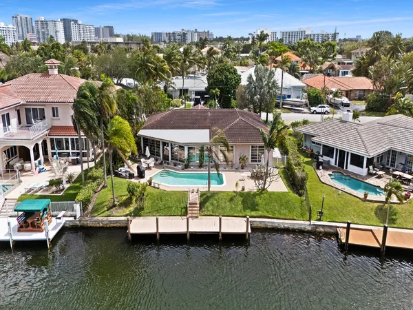 an aerial view of residential houses with outdoor space and parking