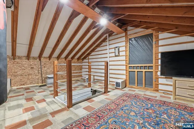 a view of a livingroom with wooden floor and a rug