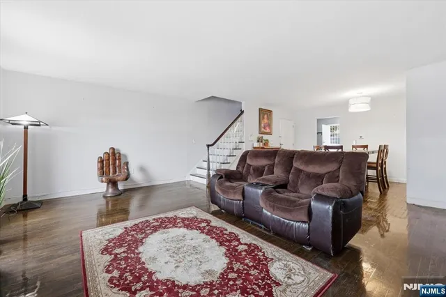 a living room with furniture a rug and a chandelier