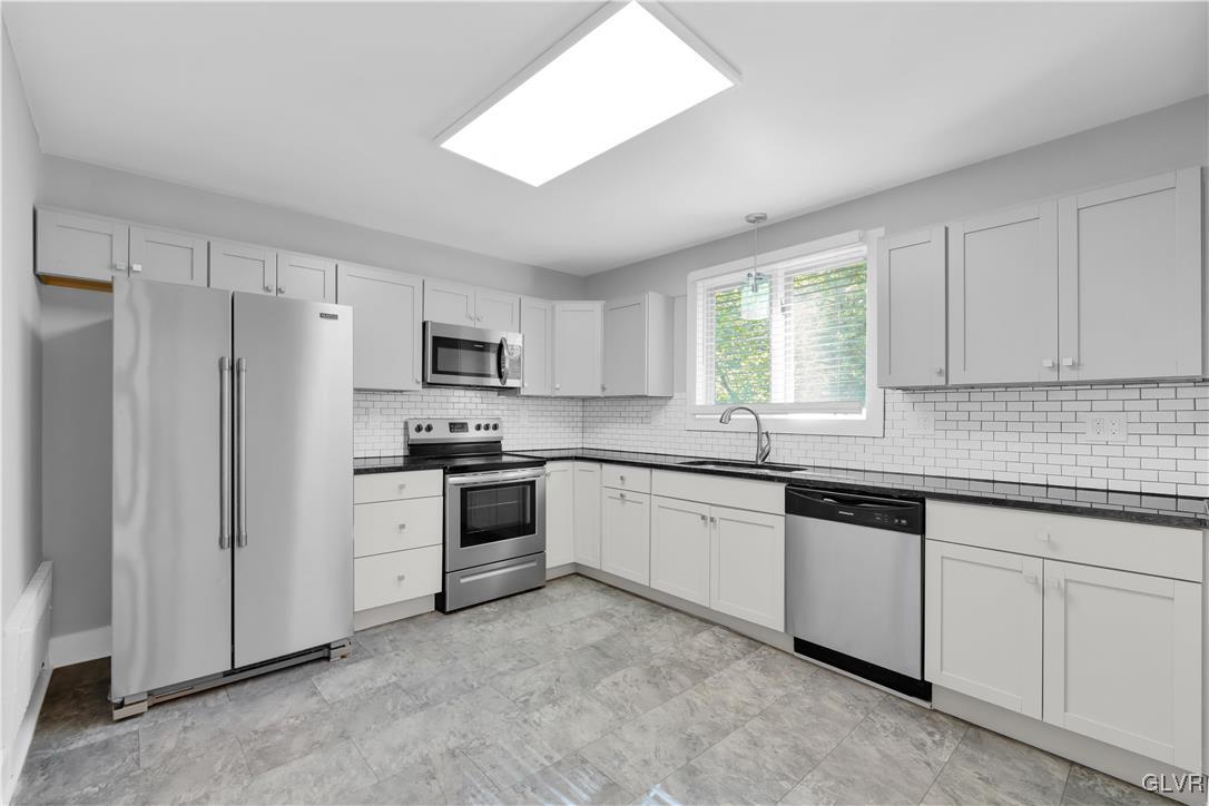 820 Morvale Road Easton, PA 18042 - Photo 22 of 50 a kitchen with granite countertop white cabinets and refrigerator