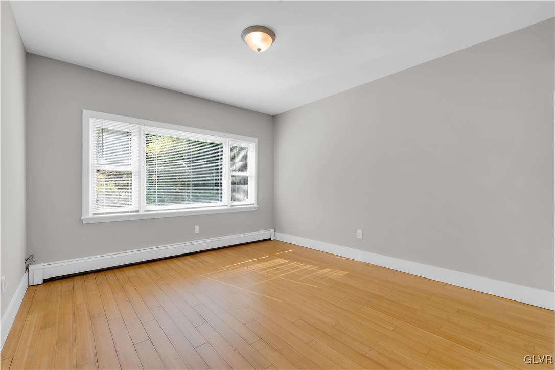 820 Morvale Road Easton, PA 18042 - Photo 25 of 50 an empty room with wooden floor and windows