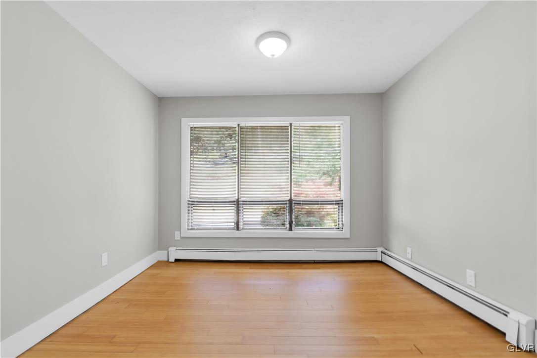 820 Morvale Road Easton, PA 18042 - Photo 27 of 50 an empty room with wooden floor and windows