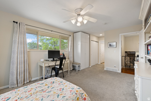 3320 Cherokee Lane Provo, UT 84604 - Photo 26 of 52 Carpeted bedroom featuring a multi-pane window, built-in cabinetry, ceiling fan with light fixture, and a built-in bookshelf