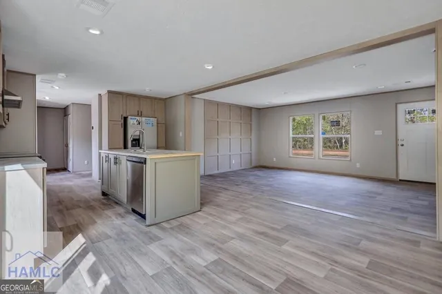 a view of a kitchen with furniture and wooden floor