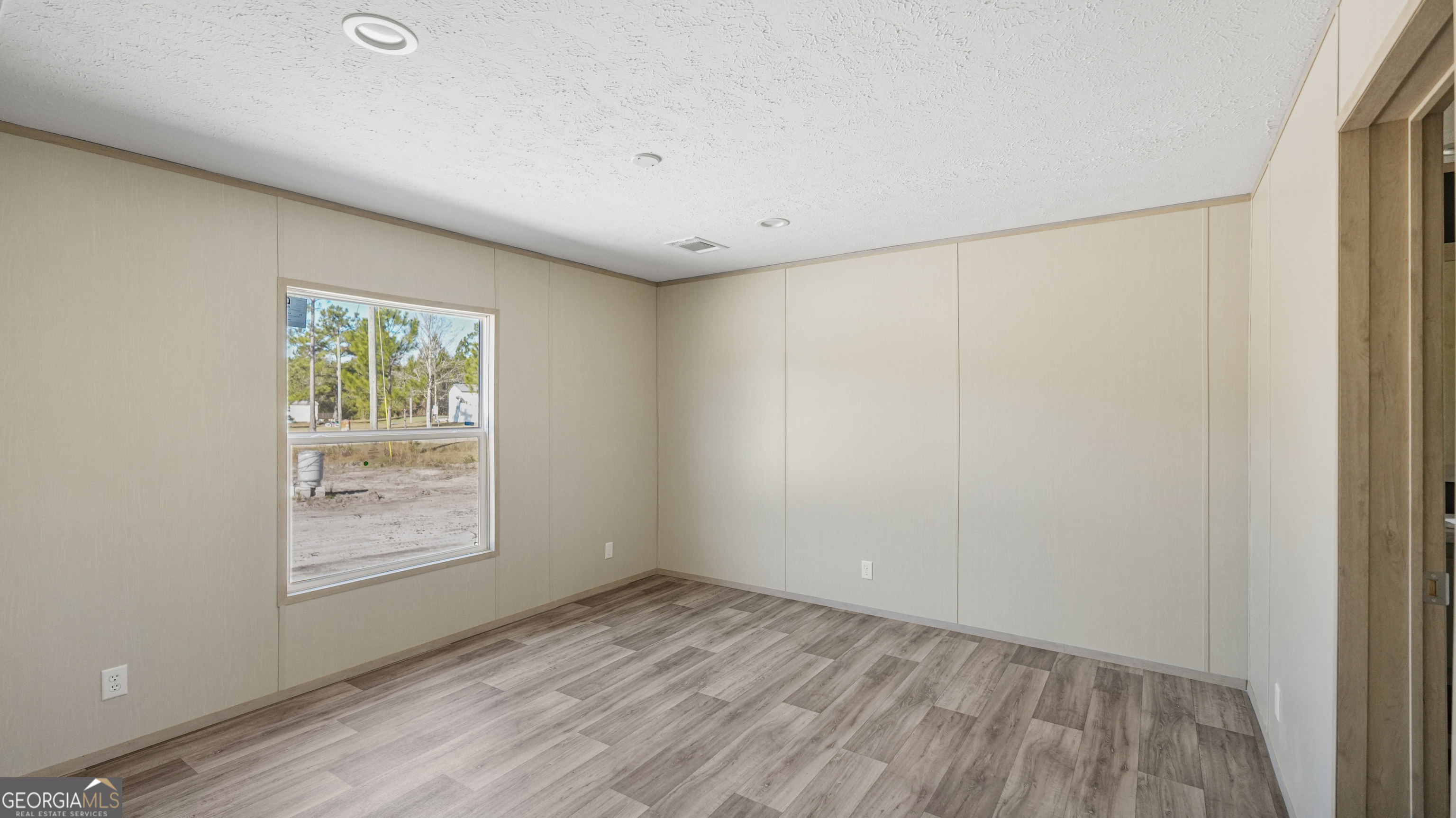123 Daniel Street Waynesville, GA 31566 - Photo 19 of 36 a view of an empty room and window