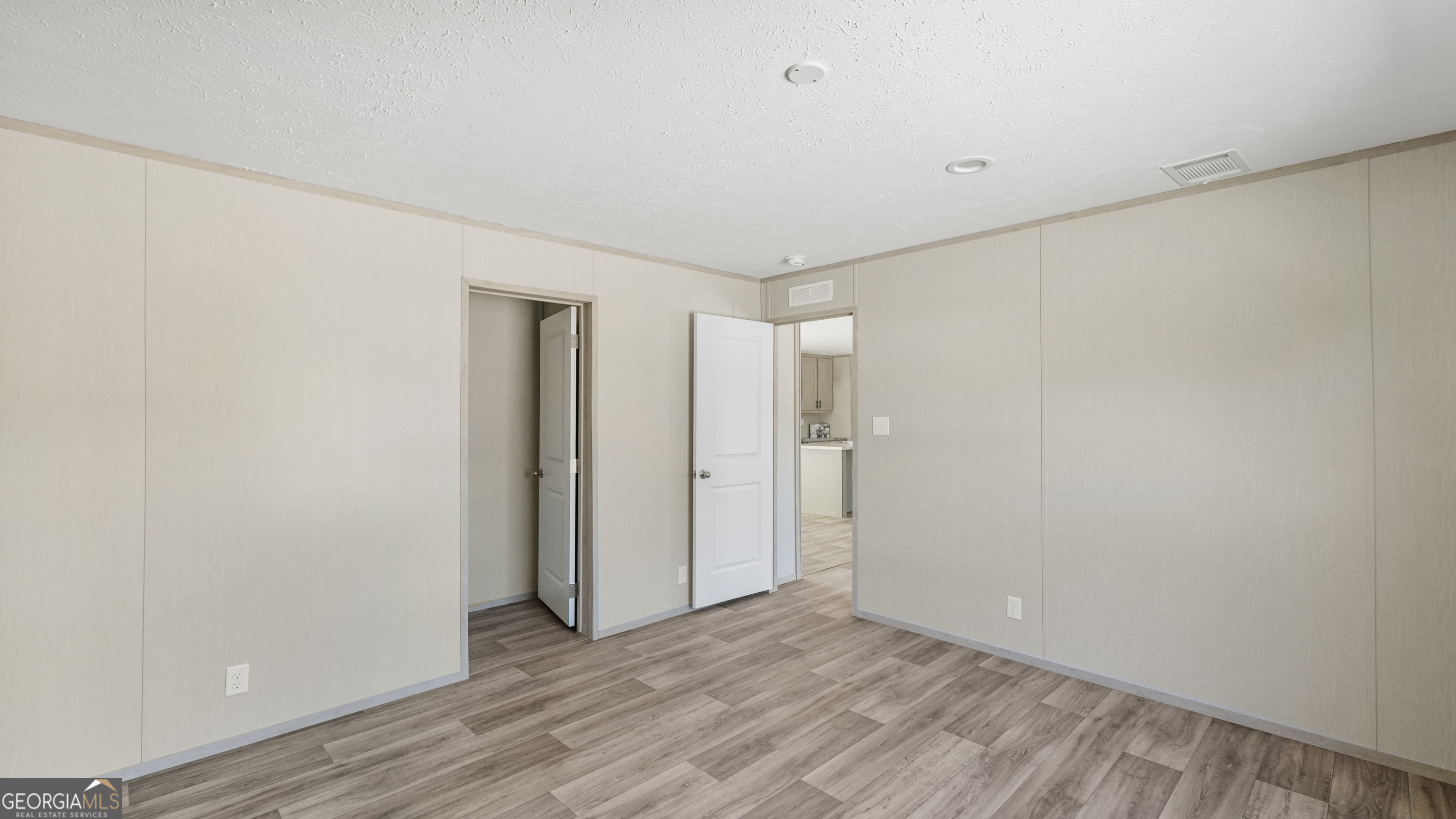 123 Daniel Street Waynesville, GA 31566 - Photo 20 of 36 a view of an empty room with wooden floor and closet