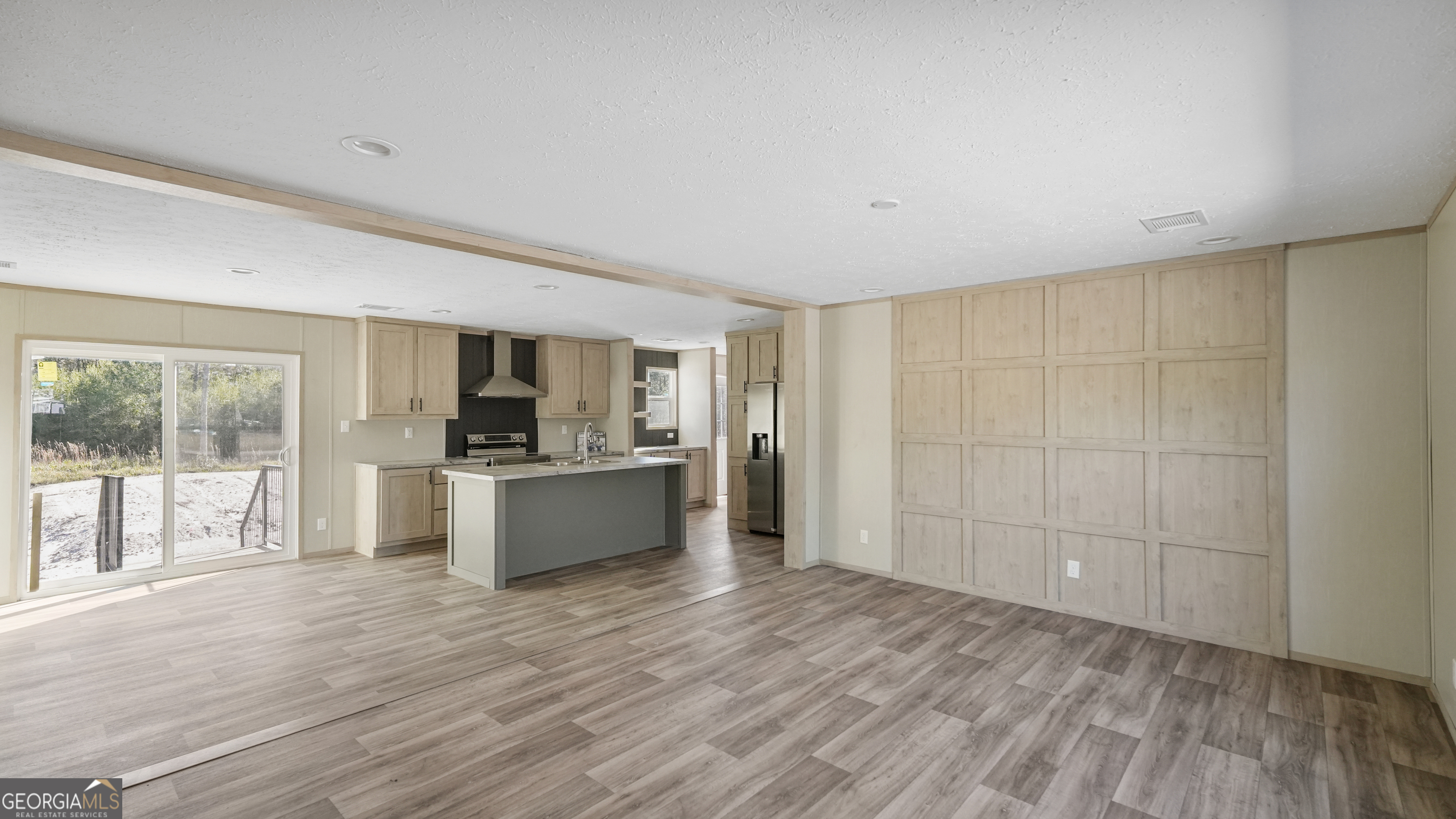 123 Daniel Street Waynesville, GA 31566 - Photo 2 of 36 a large space with a large window and wooden floor