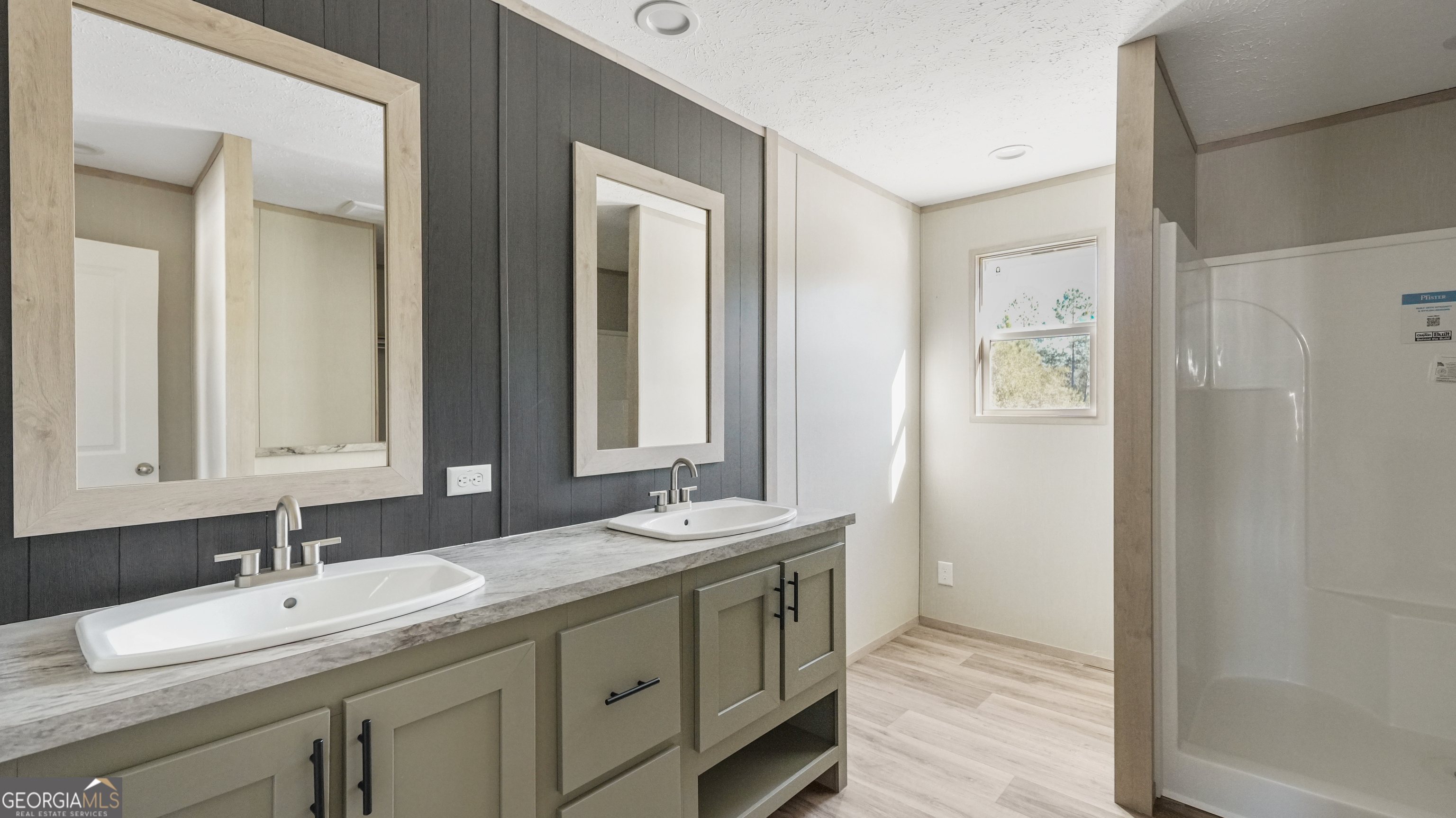 123 Daniel Street Waynesville, GA 31566 - Photo 21 of 36 a bathroom with a double vanity sink and a mirror