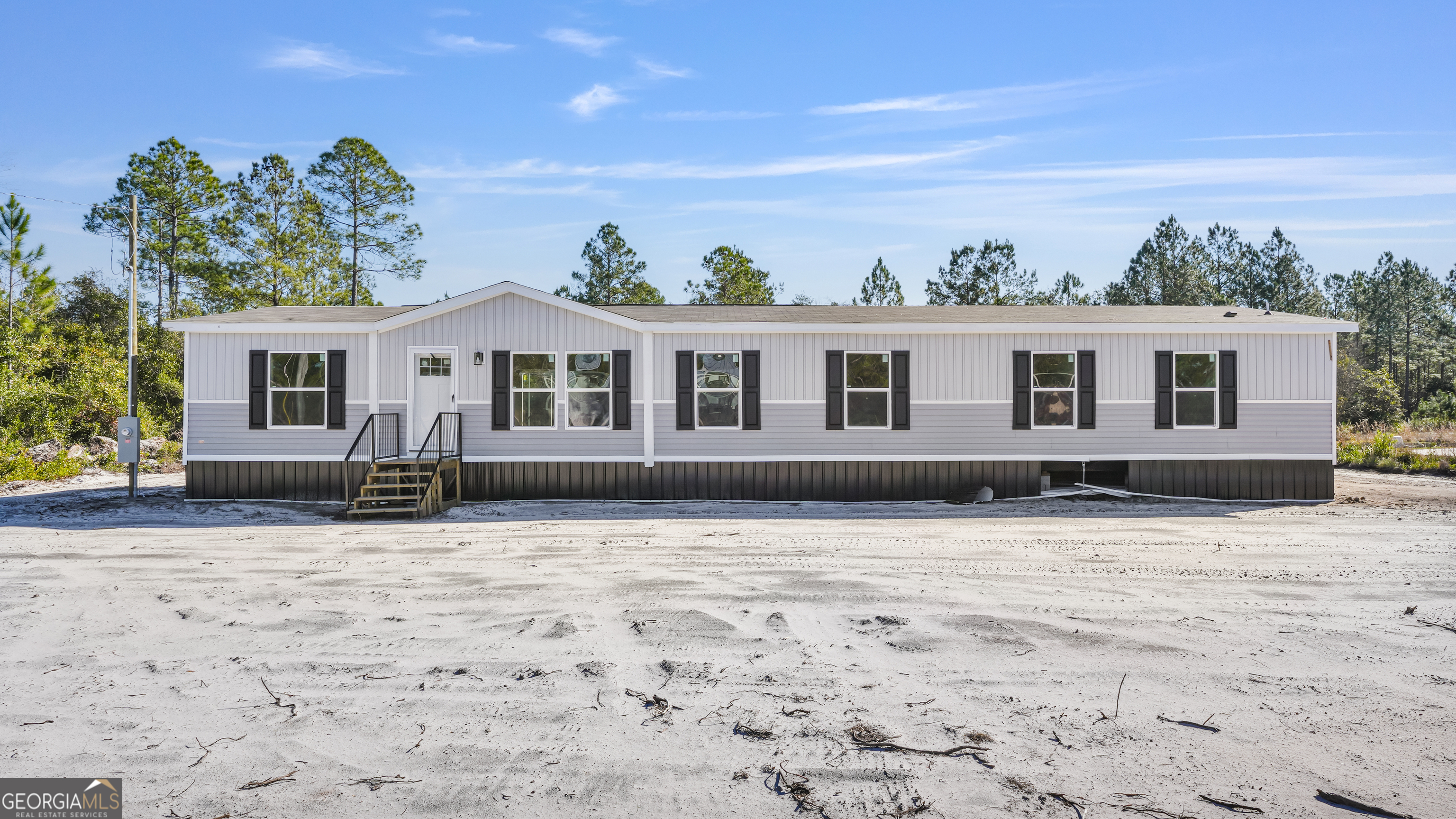 123 Daniel Street Waynesville, GA 31566 - Photo 27 of 36 a front view of a house with a yard