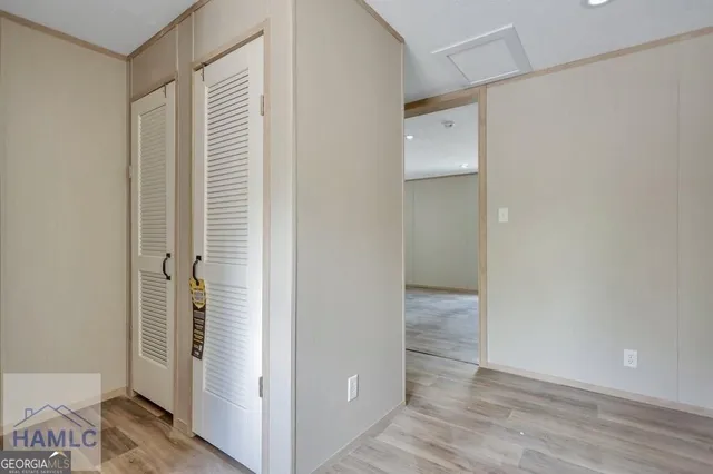 a view of a hallway with wooden floor
