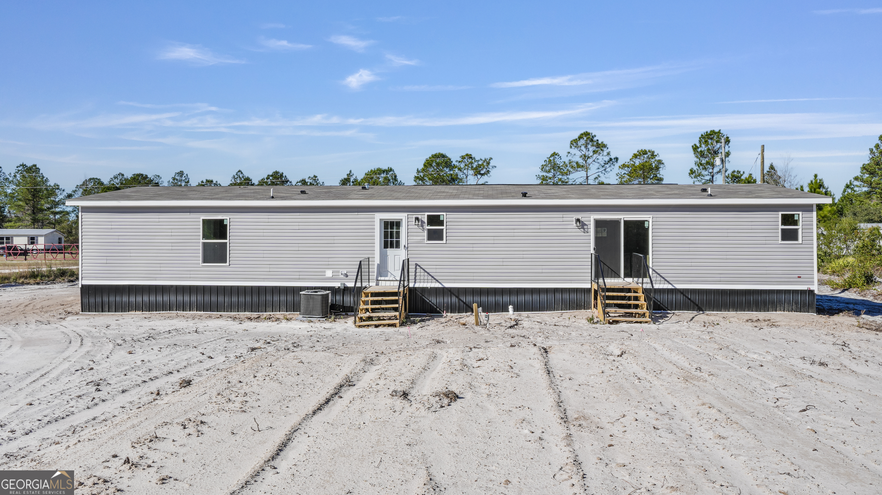 123 Daniel Street Waynesville, GA 31566 - Photo 30 of 36 front view of house with wooden fence