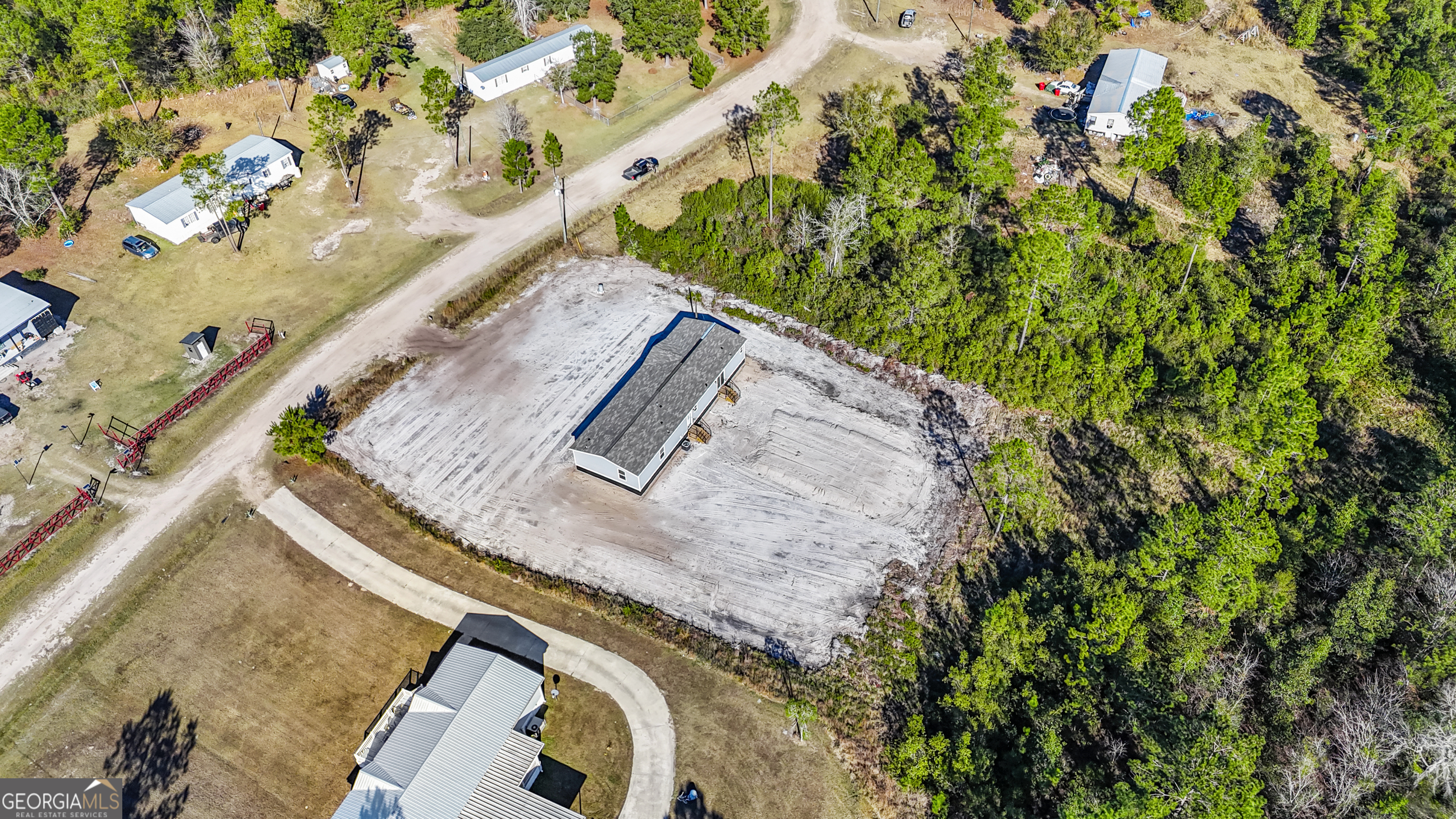 123 Daniel Street Waynesville, GA 31566 - Photo 32 of 36 a view of a yard with a trees