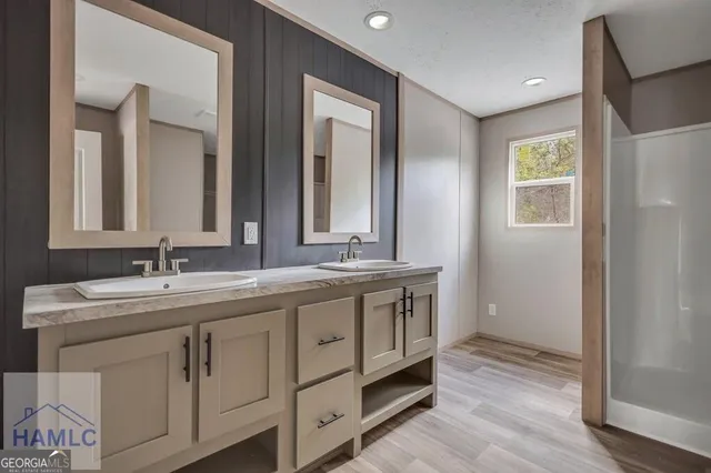 a bathroom with double sink and a mirror