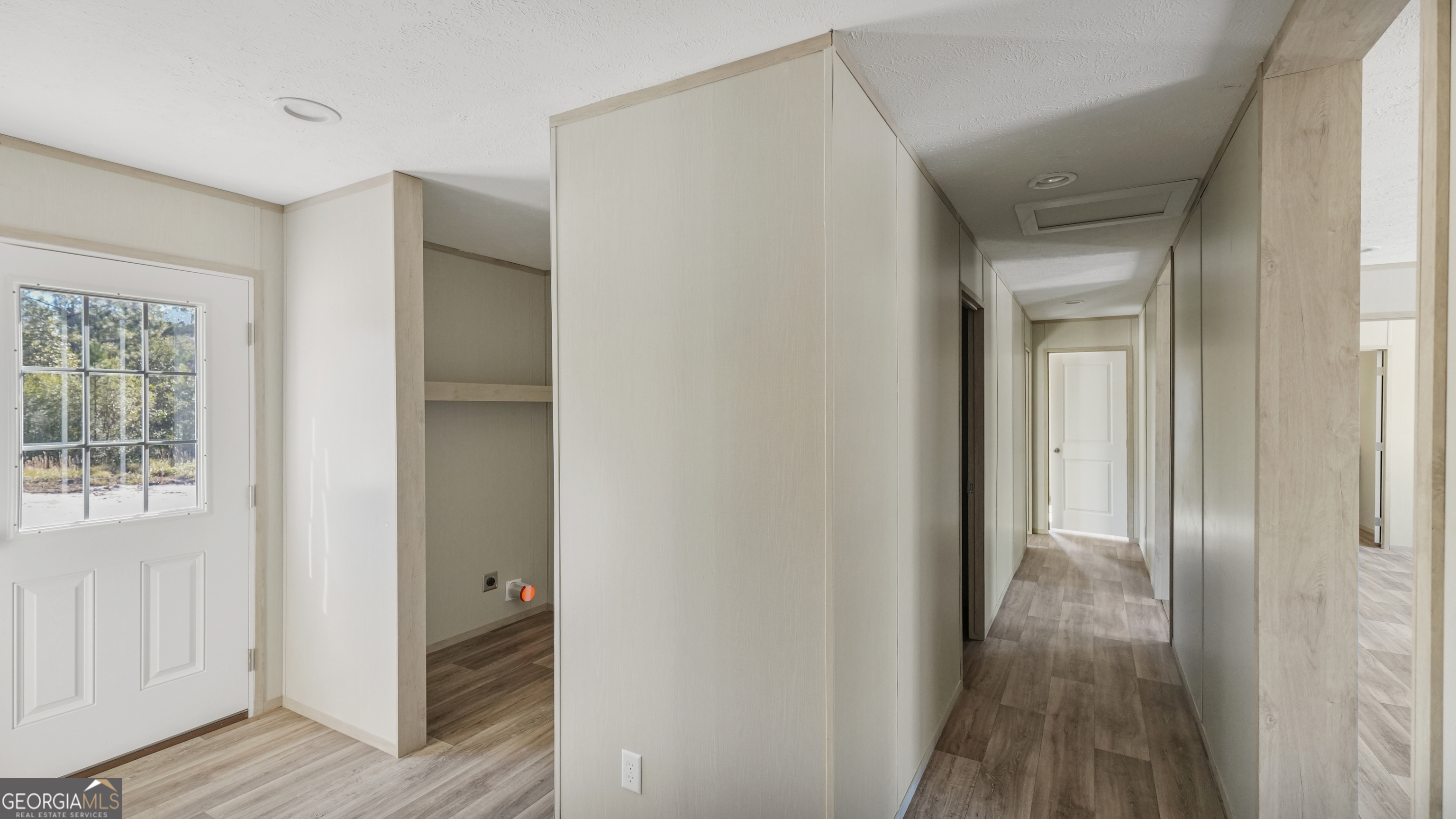 123 Daniel Street Waynesville, GA 31566 - Photo 6 of 36 a view of a hallway with wooden floor