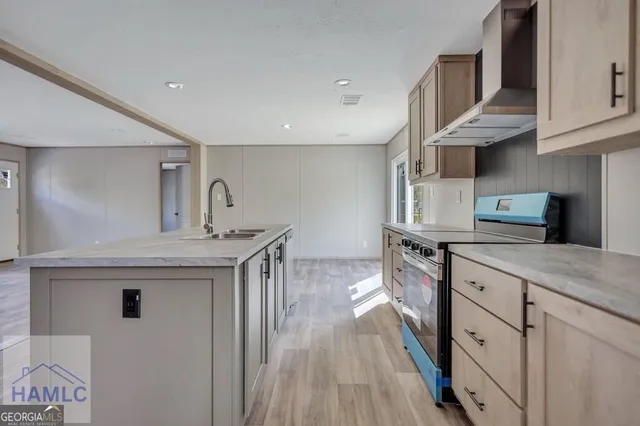 a kitchen with stainless steel appliances granite countertop a sink stove and cabinets