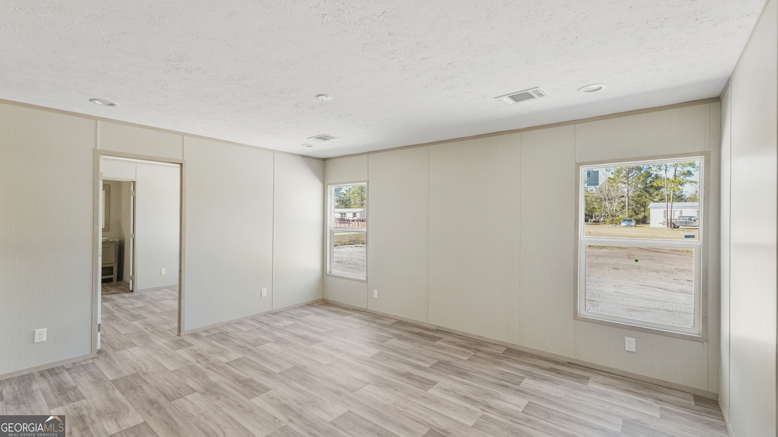 123 Daniel Street Waynesville, GA 31566 - Photo 7 of 36 wooden floor in an empty room with a window