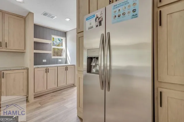 a kitchen with stainless steel appliances refrigerator a microwave and cabinets