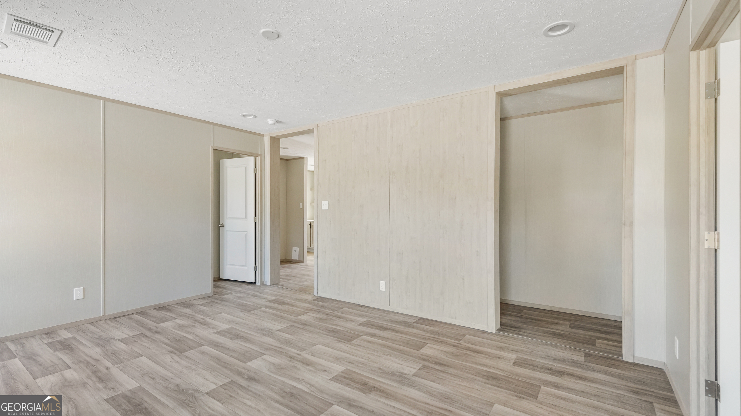 123 Daniel Street Waynesville, GA 31566 - Photo 9 of 36 a view of an empty room with wooden floor