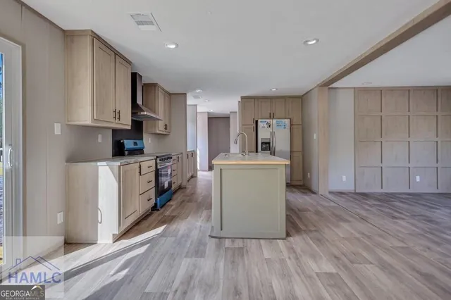 a kitchen with cabinets and wooden floor