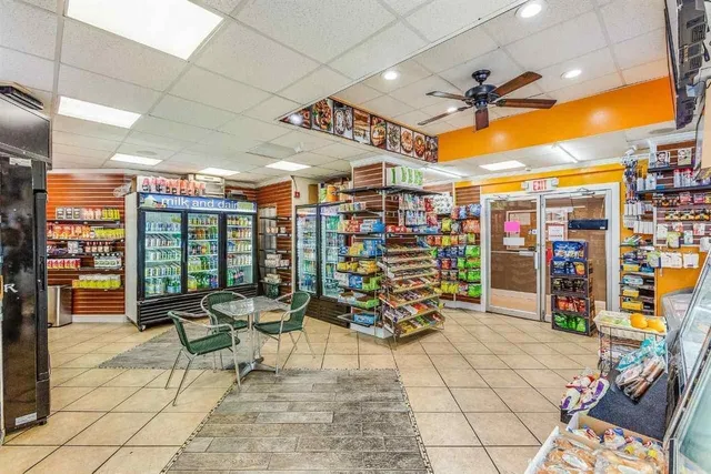 a utility room with dryer washer and a view of kitchen