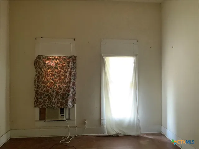 a view of a door and window in an empty room