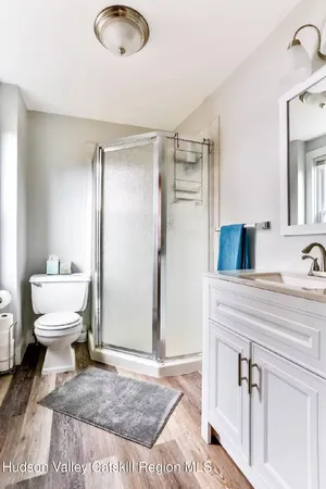 a bathroom with a sink toilet and mirror