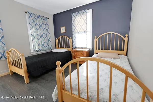 a view of a bedroom with furniture and windows