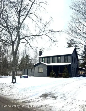 a view of house with snow on the road