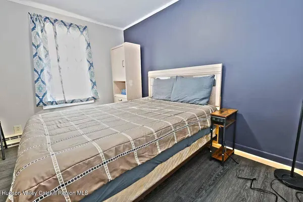 a bed sitting in a bedroom next to a white wall