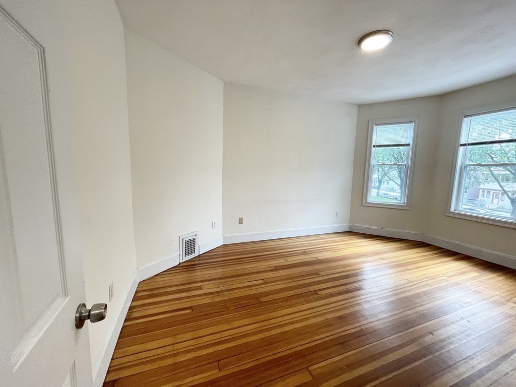 31 Edison Green, Unit 2 Boston, MA 02125 - Photo 13 of 16 a view of empty room with window and wooden floor