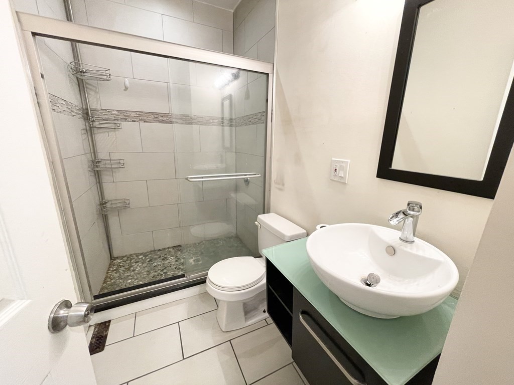 31 Edison Green, Unit 2 Boston, MA 02125 - Photo 15 of 16 a bathroom with a sink toilet and shower