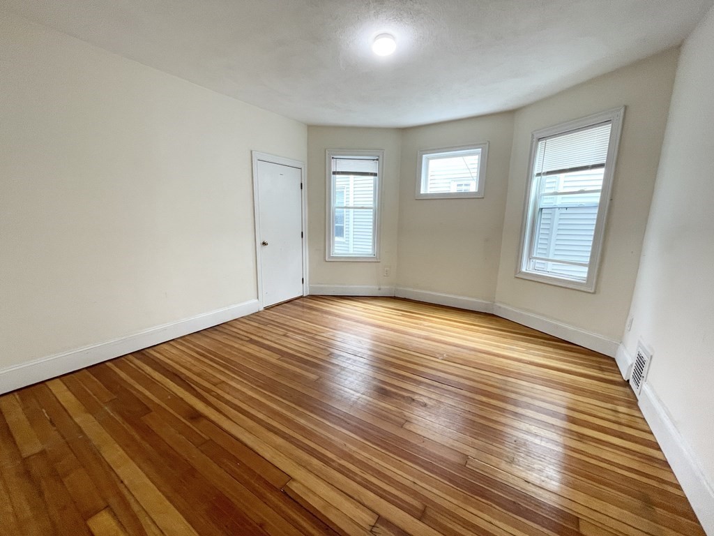 31 Edison Green, Unit 2 Boston, MA 02125 - Photo 8 of 16 a view of empty room with wooden floor and fan