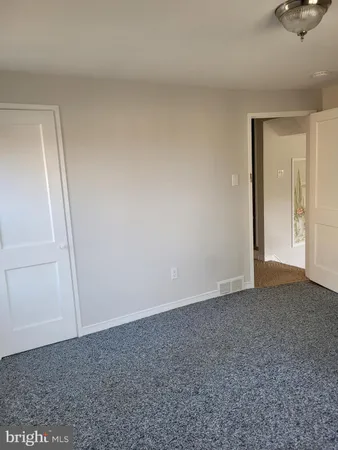 a view of an empty room and entryway
