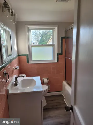 a bathroom with a sink toilet and mirror