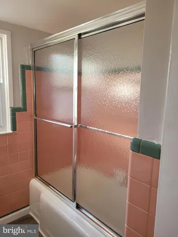 a bathroom with a glass shower door