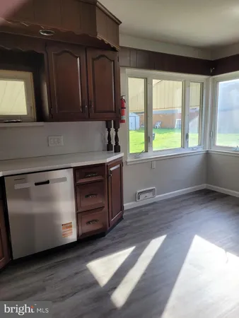 a kitchen with wooden cabinets and a wooden floors