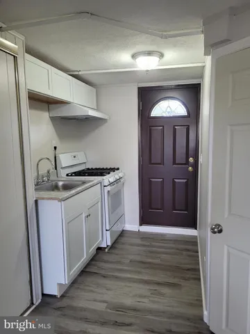 a kitchen with granite countertop a cabinets and a stove
