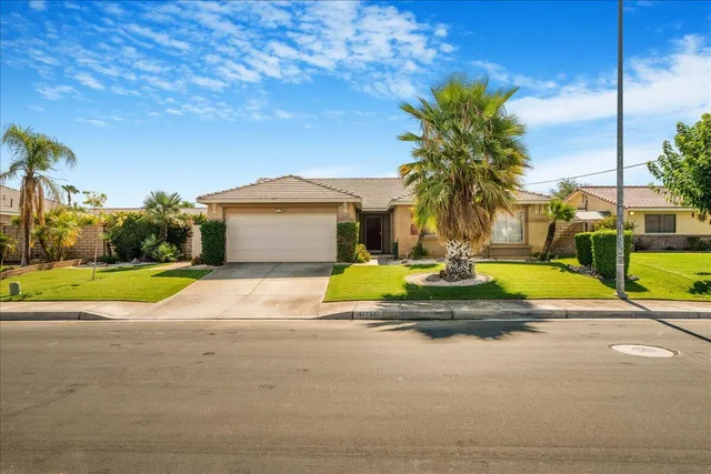 a view of swimming pool with palm trees