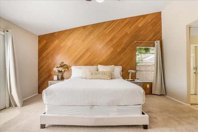 a bedroom with a bed a couch and a window