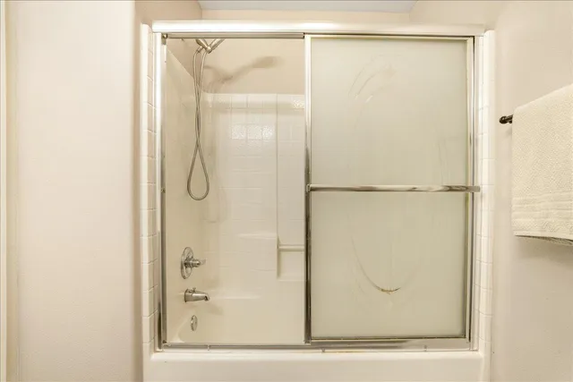 a bedroom with a large bed and a flat tv screen on dresser