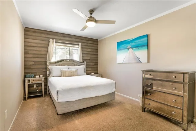 a bedroom with a bed and a mirror