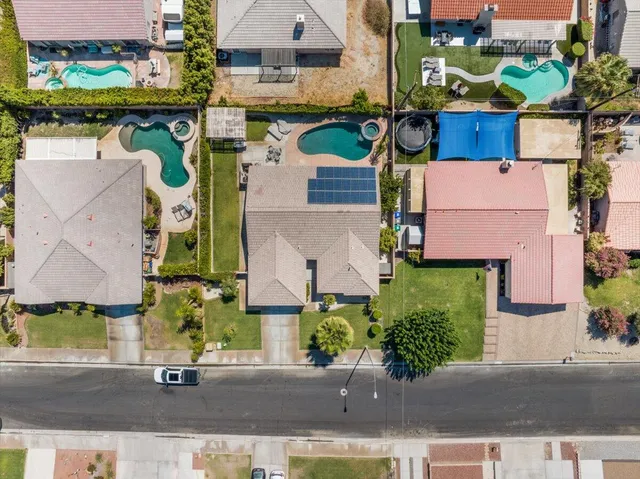 an aerial view of residential houses with yard