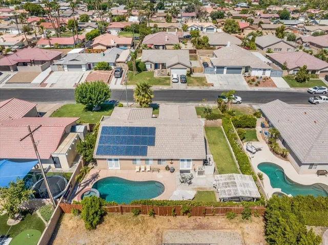 an aerial view of residential houses with outdoor space