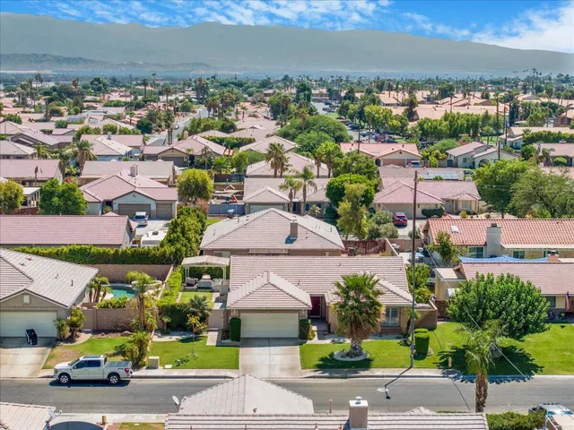 an aerial view of a house with swimming pool and outdoor space