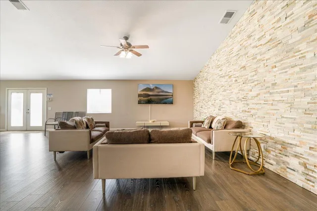 a living room with couches and a coffee table with wooden floor