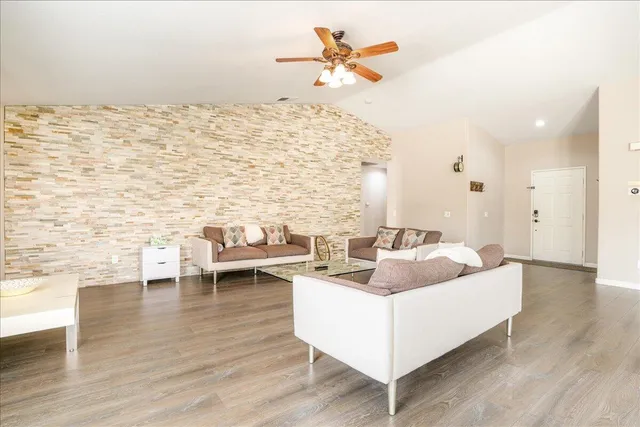 a living room with furniture and wooden floor