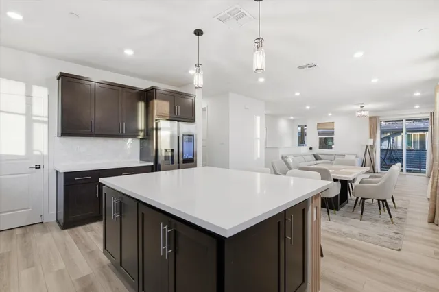 a large kitchen with a table and chairs